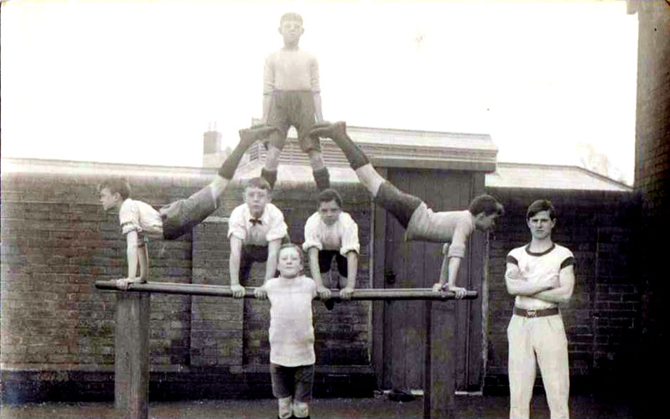 Alfred (at right) teaching gymnastics