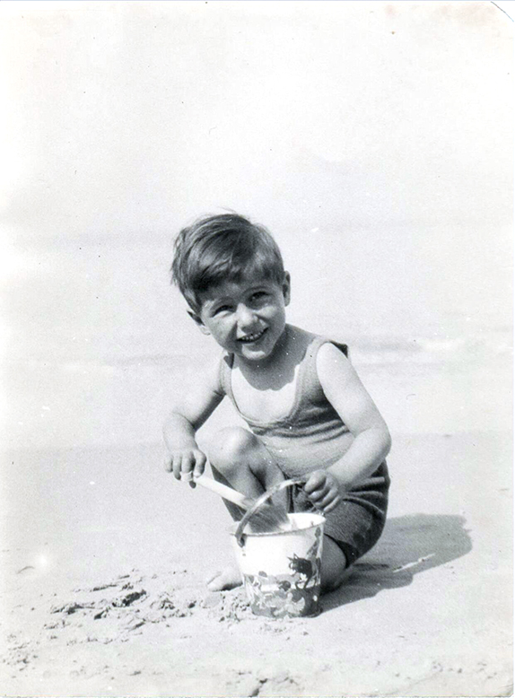 Richard as a young boy playing on the beach